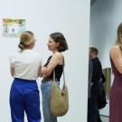 Guests gather in front of art exhibit at the Manetti Shrem Museum of Art