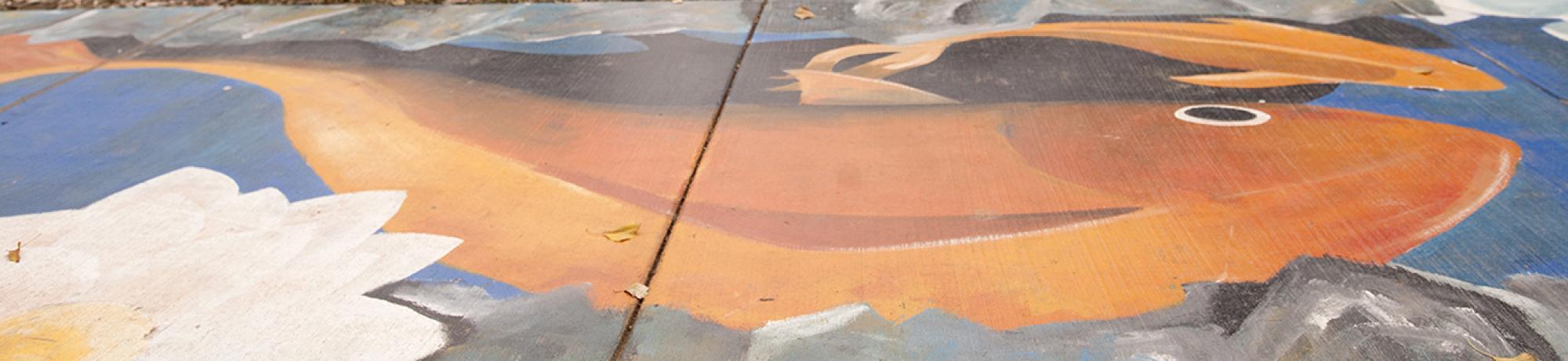 A sidewalk mural of a fish from the Nelson Gallery at UC Davis